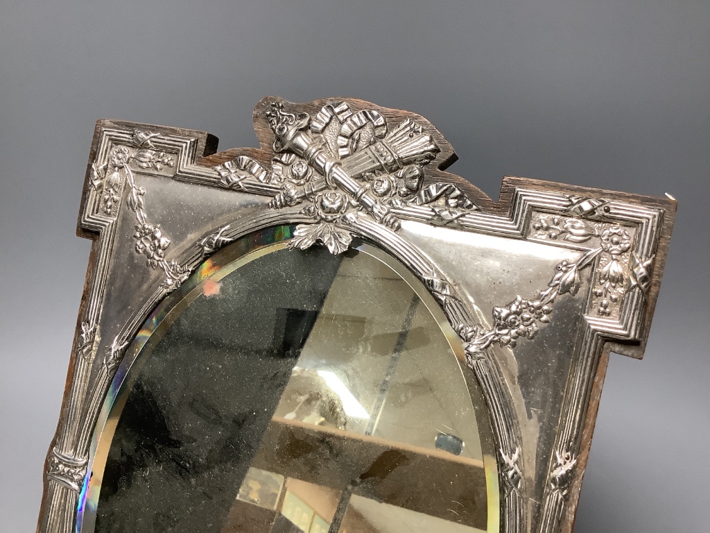 An Edwardian silver mounted easel mirror, with oval plate, James Deakin & Sons, Birmingham, 1908, 29.8cm.